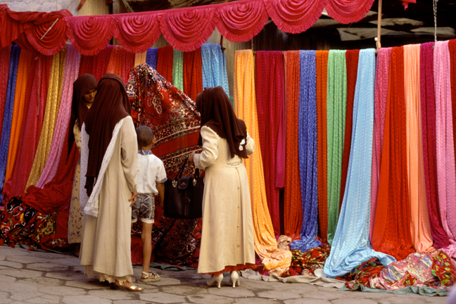 Farbic market bargaining, Kashgar, China